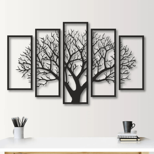Set of five framed black tree silhouettes on a white wall